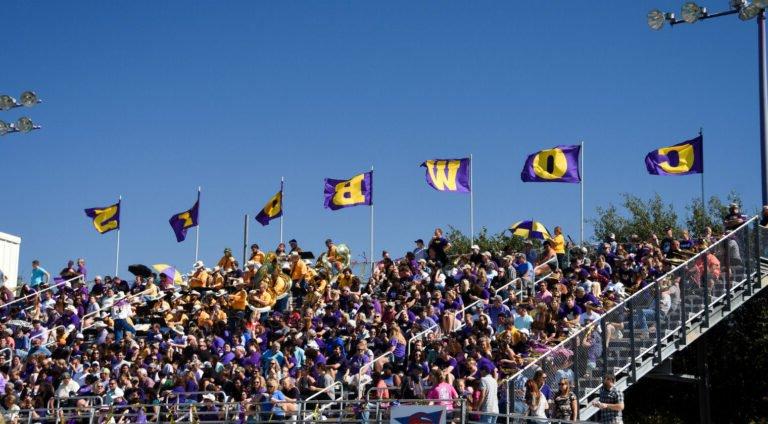 HSU football fans in the stands wearing school colors